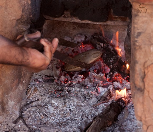 In goes the roti to get baked in the tandoor